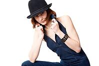 Young woman with hat isolated on the black background [IBR124968472]