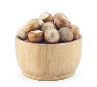 Ripe hazelnuts wooden saucer on a white background [IBR124991127]