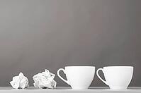 Creative process. crumpled wads and cup on gray [IBR125000237]