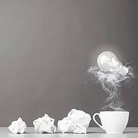 Creative process. crumpled wads and cup on gray [IBR125000238]