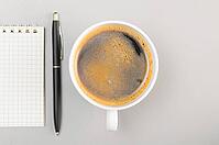 Creative process. blank notebook and cup on gray [IBR125000241]
