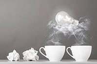 Creative process. crumpled wads and cup on gray [IBR125000242]