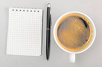 Creative process. blank notebook and cup on gray [IBR125000243]