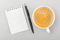 Creative process. blank notebook and cup on gray [IBR125000244]