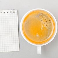 Creative process. blank notebook and cup on gray [IBR125000245]