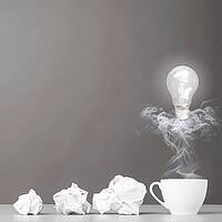 Creative process. crumpled wads and cup on gray [IBR125000247]