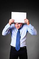 Businessman is holding blank banner in hands [IBR125000248]