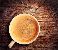 Cup of fresh espresso on table, view from above [IBR125000251]