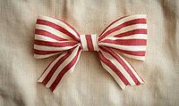 Simple red and white striped ribbon bow on a beige linen background. AI generated [IBR125000273]