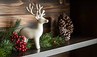 Rustic holiday scene with a white ceramic reindeer on a dark wooden shelf, surrounded by a few green sprigs and red berries. AI generated [IBR125000285]
