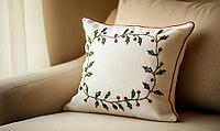 White linen pillow with red and green holly embroidery, set against a beige sofa in a minimalist living room. AI generated [IBR125000307]