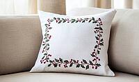 White linen pillow with red and green holly embroidery, set against a beige sofa in a minimalist living room. AI generated [IBR125000316]