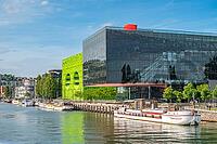 Modern, contemporary architecture on the banks of the Saone Quai Rambaud with Pavilion 8 designed by Odile Decq and the eye-catching green Cube Vert by Dominique Jakob and Brendan MacFarlane and moored Peniche barges in the revitalized La Confluence harbo [IBR125002334]