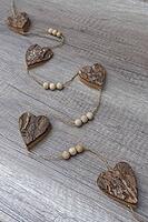 Wooden hearts, strung on a cord, Kempen, Viersen District, North Rhine-Westphalia, Germany [IBR125007595]