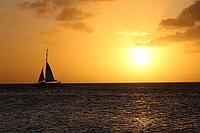 A majestic sunset sailing scene over the ocean. Golden idyllic Aruba vacation landscape.Tranquil peaceful backdrop [IBR125026131]