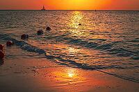 Sunset at sea with the coast in and safety buoy view. a beautiful nature landscape for safety and tranquil peace of mind themes and concepts [IBR125026142]