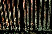 Close-up of rusty metal bars of drain grate pattern grunge background. isolated on black mysterious backdrop from pipe or tunnel [IBR125026220]