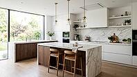 A spacious, contemporary kitchen featuring a waterfall marble island, sleek cabinetry, and abundant natural light from a floor-to-ceiling window, AI generated [IBR125026407]