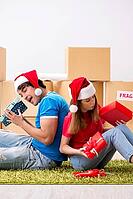 Young family celebrating christmas in new home [IBR125053201]