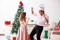 Young pair celebrating christmas at home [IBR125053202]
