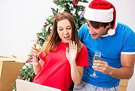 Young family celebrating christmas in new home [IBR125053203]