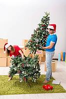 Young family celebrating christmas in new home [IBR125053207]