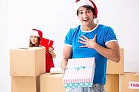 Young family celebrating christmas in new home [IBR125053210]