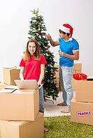 Young family celebrating christmas in new home [IBR125053211]
