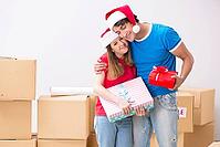 Young family celebrating christmas in new home [IBR125053212]