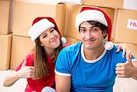 Young family celebrating christmas in new home [IBR125053213]