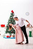 Young pair celebrating christmas at home [IBR125053214]