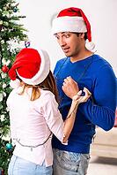 Young family celebrating christmas at home [IBR125053226]
