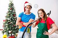 Young family cleaning apartment after christmas party [IBR125053227]