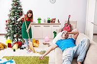 Young family cleaning apartment after christmas party [IBR125053229]