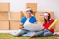 Young family celebrating christmas in new home [IBR125053231]