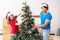Young family celebrating christmas in new home [IBR125053232]