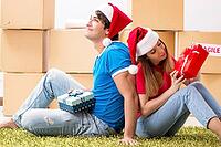 Young family celebrating christmas in new home [IBR125053233]
