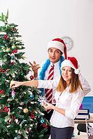 Colleagues celebrating christmas in office [IBR125053235]