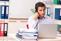 Young employee sitting at the office [IBR125053236]