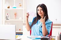 Young beautiful female doctor working in the clinic [IBR125053238]