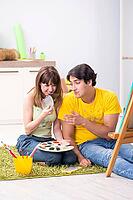 Young couple enjoying painting at home [IBR125053239]