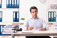 Young employee sitting at the office [IBR125053240]