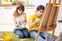 Young couple enjoying painting at home [IBR125053244]