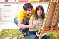 Young couple enjoying painting at home [IBR125053245]