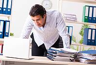 Young employee sitting at the office [IBR125053248]