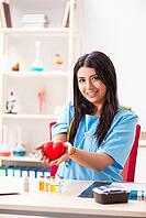 Young beautiful female doctor working in the clinic [IBR125053249]