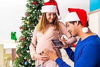 Pregnant wife celevrating christmas with husband [IBR125053250]
