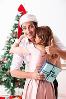 Young couple celebrating christmas at home [IBR125053251]