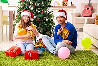 Young couple celebrating christmas at home [IBR125053258]