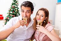 Young couple celebraring christmas with champagne [IBR125053260]